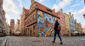 A professional, artistic shot of a vibrant, large-scale modern mural on a renovated historical build