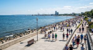 A professional, high-angle editorial photograph of Gdynia’s seaside promenade during a sunny day, fe