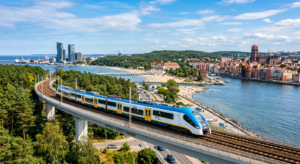 A sleek, modern commuter train gliding through a scenic landscape connecting Gdansk, Gdynia, and Sop