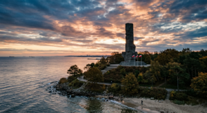 A high-quality, atmospheric editorial photograph of the historic Westerplatte monument standing agai